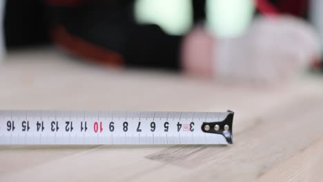 close-up of a tape measure on a wooden surface