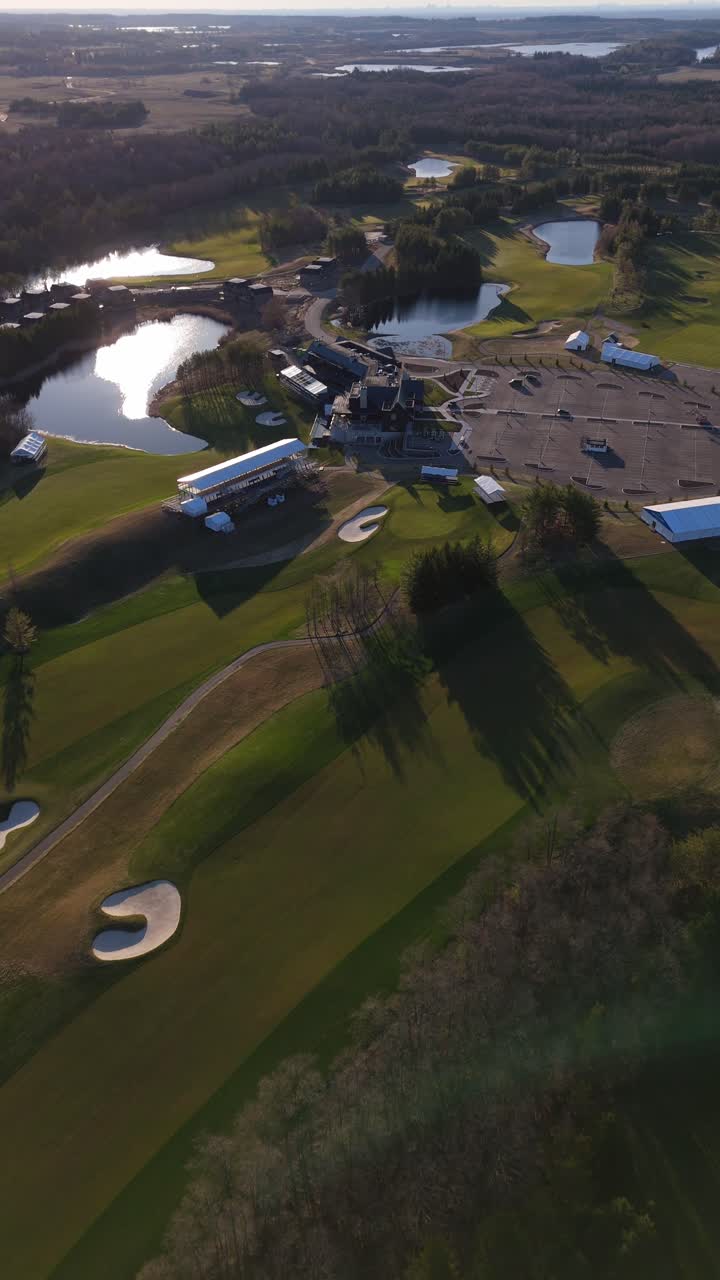 Vertical View Of Electric Vehicle Charging Station Across TPC Toronto At Osprey Valley Golf Course In Canada. Aerial Drone Shot