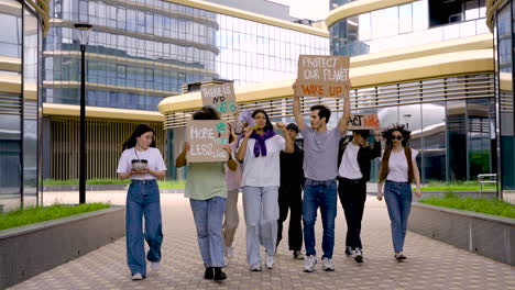 group of people in a protest using megaphones and holding placards