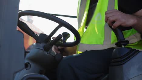 close-up of a worker operating heavy machinery controls