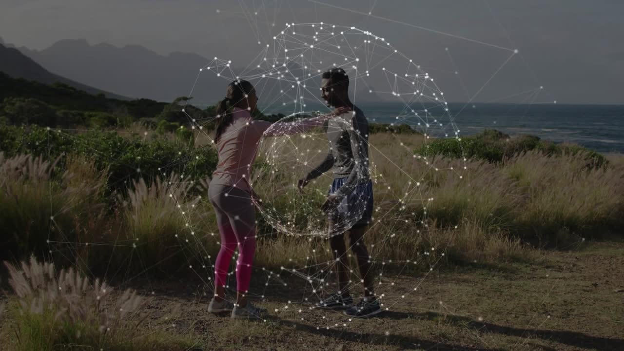 Partners pressing shoulders, stretching quad on coastal trail, digital sphere pulsing for fitness