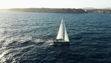 side shot with a drone of a sailboat in majorca