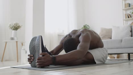 man stretching at home