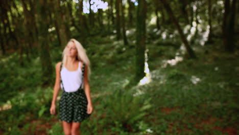 attractive blonde walking through forest