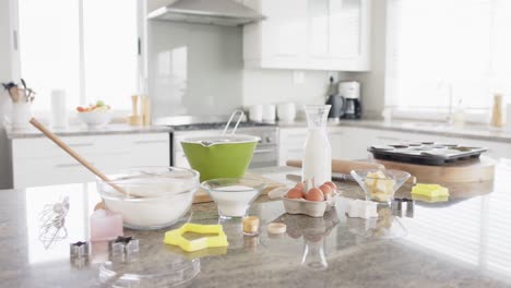 General-view-of-kitchen-with-baking-ingredients-and-equipment-on-countertop,-slow-motion