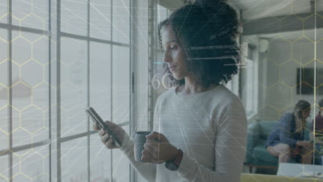 animation of 6g text and data over biracial casual businesswoman using smartphone in office