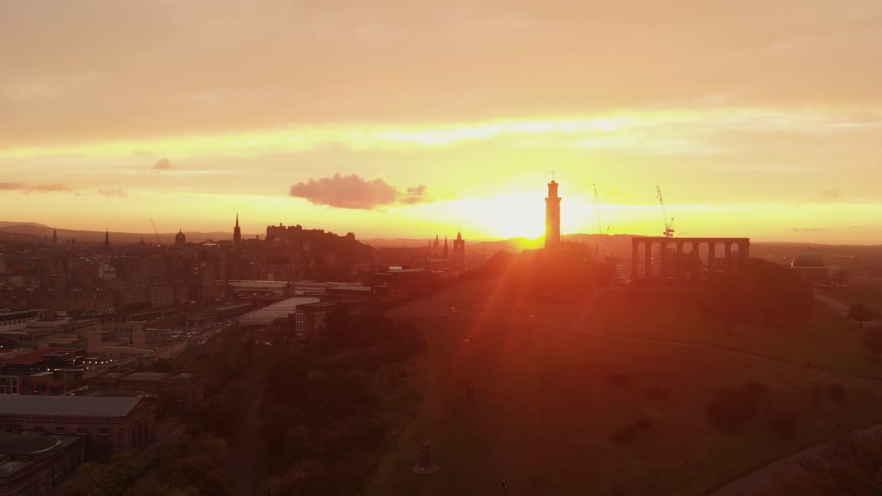 Aerial view of beautiful Edinburgh Scotland during dramatic sunset- Drone gaining altitude from Calton Hill