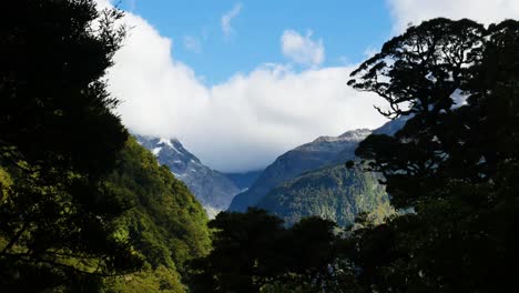 pan of forested mountains with clouds