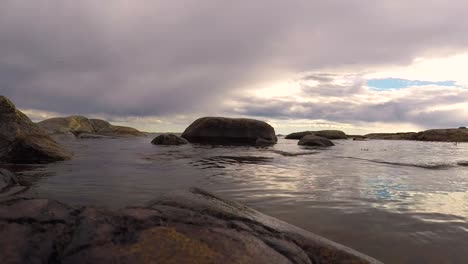 calm peaceful sea waves hitting rocks in the island summertime in sweden