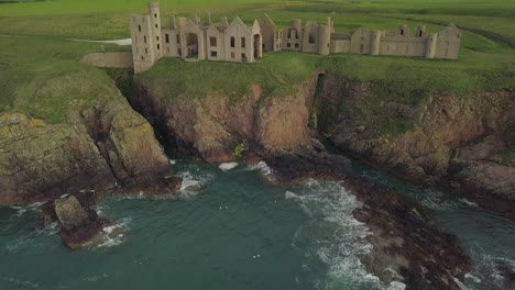 Aerial-view-of-a-Slains-Castle-ruin-at-sunrise,-Aberdeenshire,-Scotland