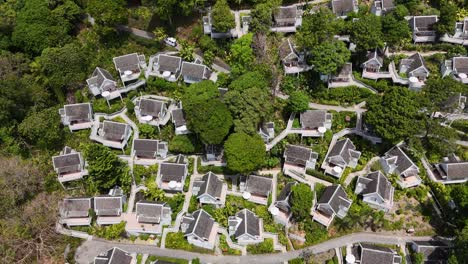 aerial view of a lush thai resort with villas, showcasing vibrant greenery and modern architecture under bright daylight