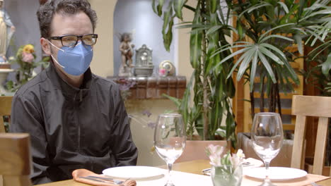 man having dinner in restaurant