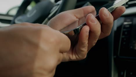 person using a smartphone in a car