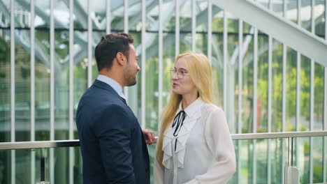 business people talking on a modern office balcony