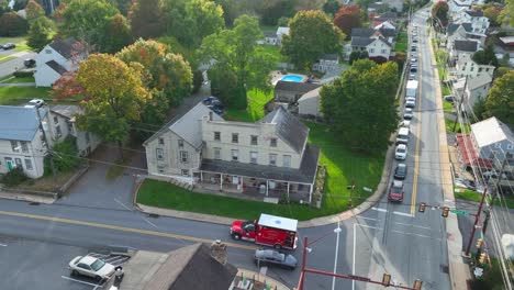 aerial tracking shot of an ambulance responding to 911 medical emergency in small town usa