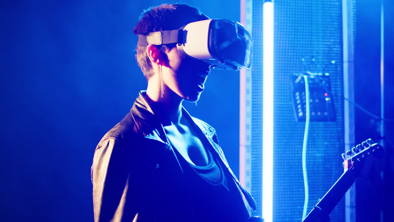 Person playing guitar with VR headset in neon lit room