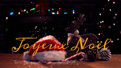 animation of joyeux noel text over christmas decorations