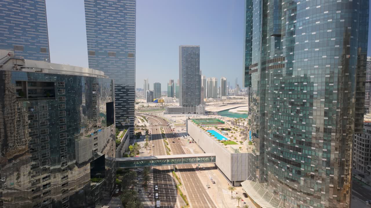 Al 'Oud Street in Abu Dhabi, Al Reem Island, United Arab Emirates - tilt up to reveal the city skyline at daytime