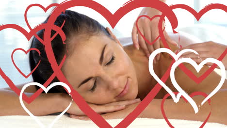 masseuse doing massage to relaxed attractive women at spa with hearts for valentines day 4k