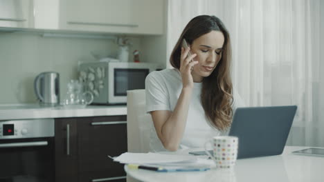 Sad-woman-using-phone-at-home-workplace.-Upset-woman-talking-mobile-phone