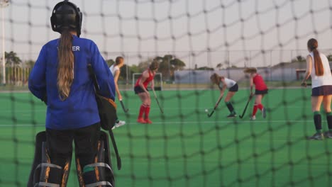 female hockey players playing on the field