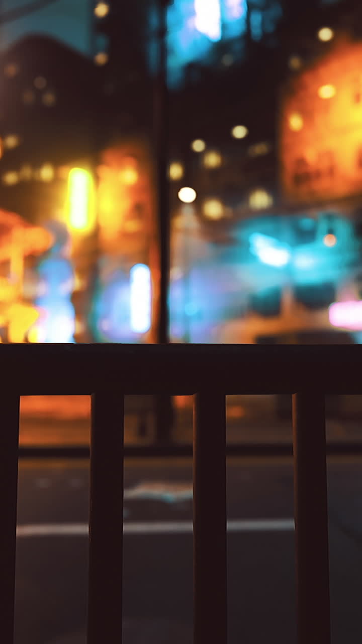 Nighttime cityscape with vibrant neon lights illuminating the street