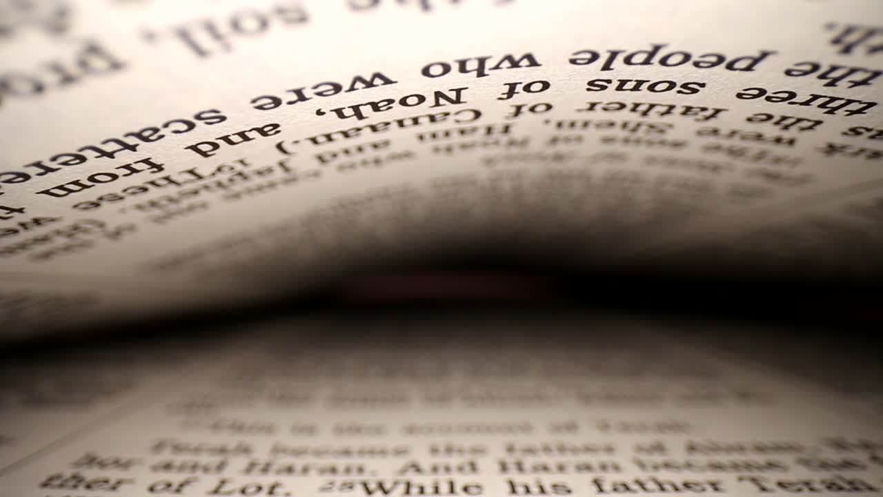 Slowly pushing lens into a book at a words eye view of the pages, pages on both top - bottom of viewpoint