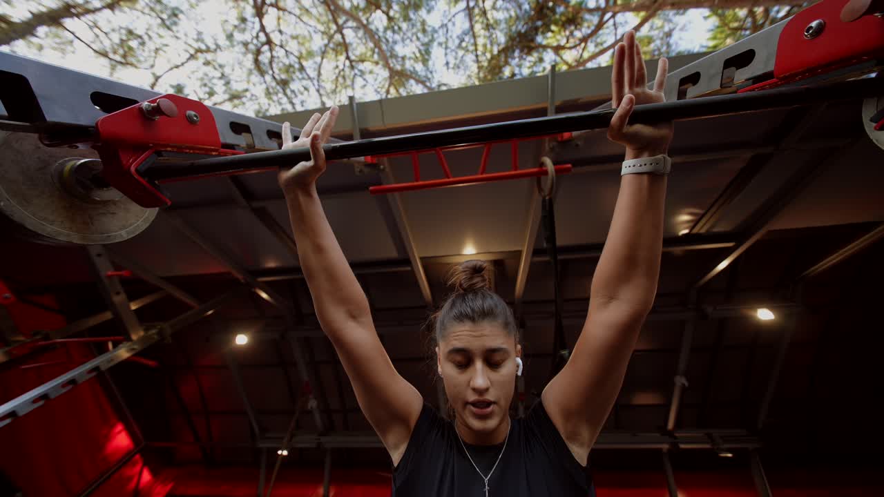 Woman Doing Pull-Ups Outdoors