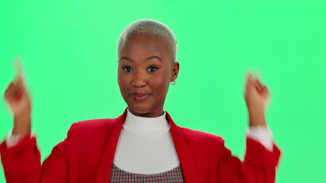 Woman with short hair in red blazer smiles against green background