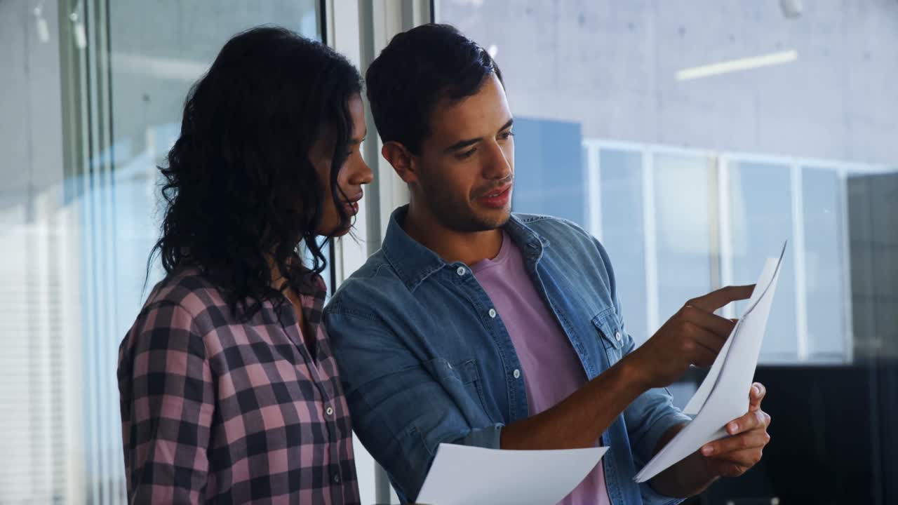 Colleagues discussing over documents