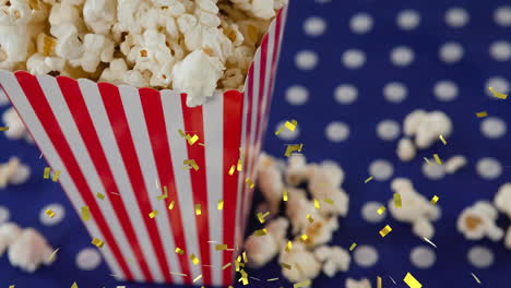 animación de confeti dorado sobre una caja de palomitas de maíz