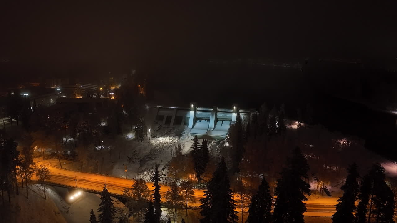 Aerial view circling the Imatrankoski dam, winter evening in Imatra, Finland