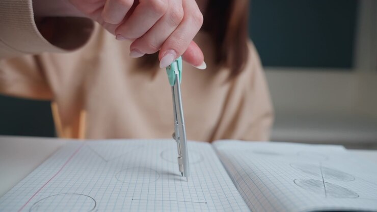 Student practicing geometry with compass. Focused student illustrating precise angles and shapes quietly. Calm student concentrating on detailed compass work with ruler and notebook at home