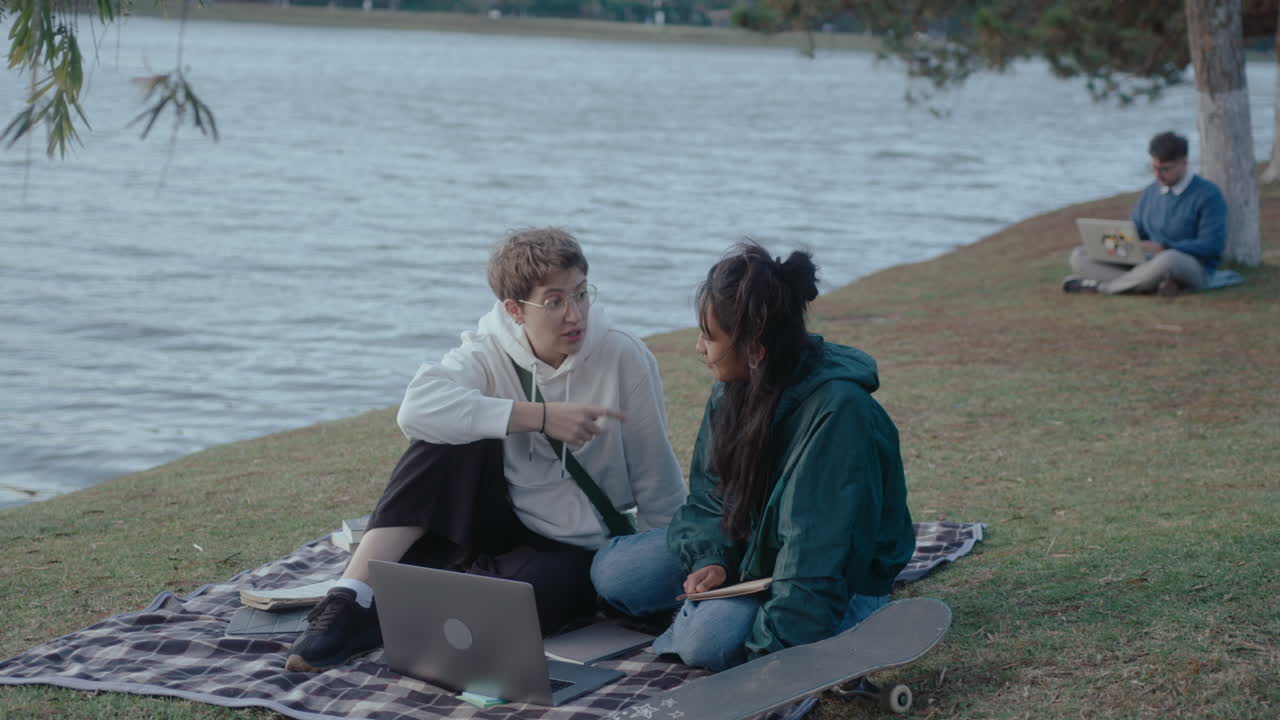 Girls Sitting with Laptop in the Park and Talking