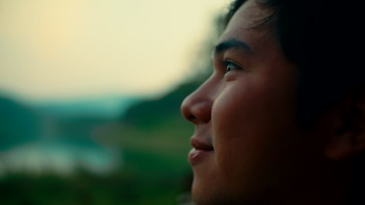 Man looking at the horizon at sunset