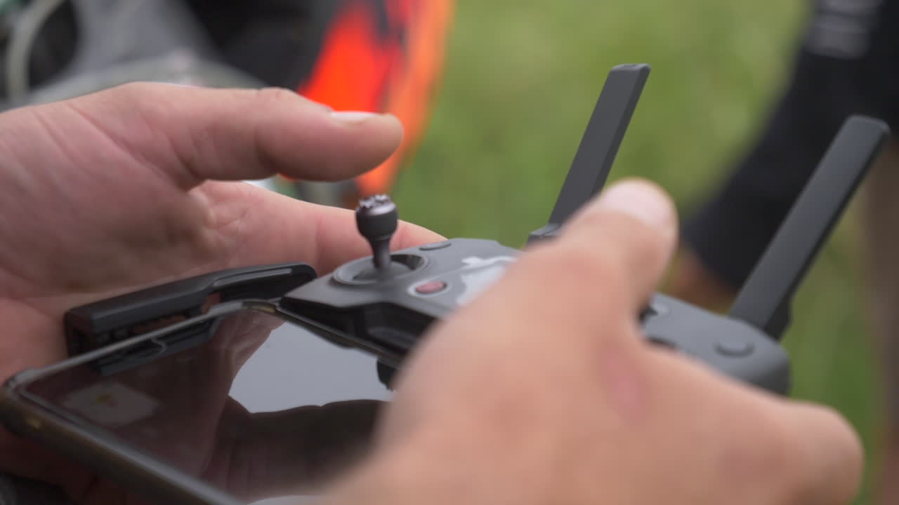 Drone pilot operating his drone from his phone.