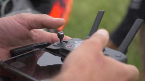 drone pilot operating his drone from his phone.