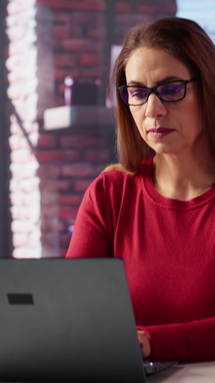 Vertical Video Mature person overseeing business schedule and planning activities at desk