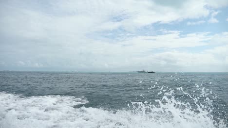 water rushes by the side of a boat as it soars through the caribbean sea