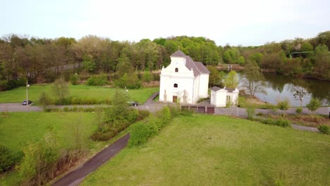 aerial view of a white church by a lake
