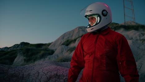 astronaut walks in dry lands before sitting down and turning on a sensor