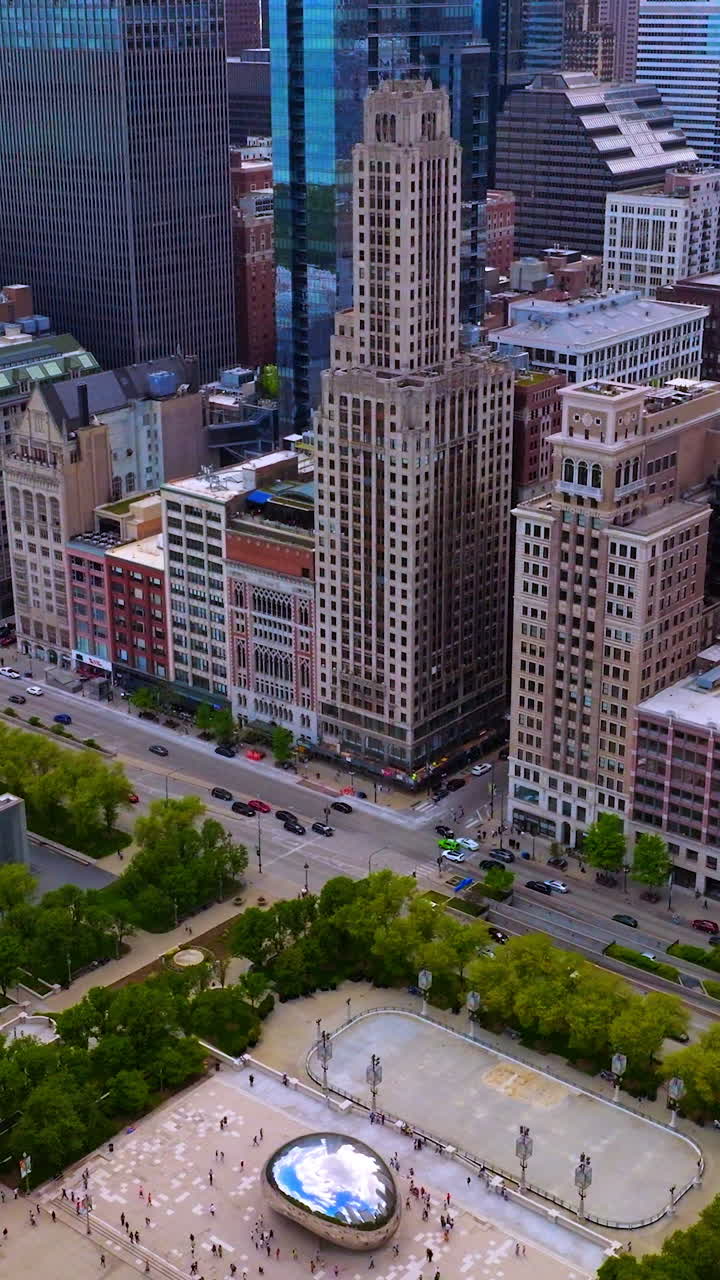Amazing buildings towering over the road full of cars. Green park areas neighboring with dense architecture. Vertical video