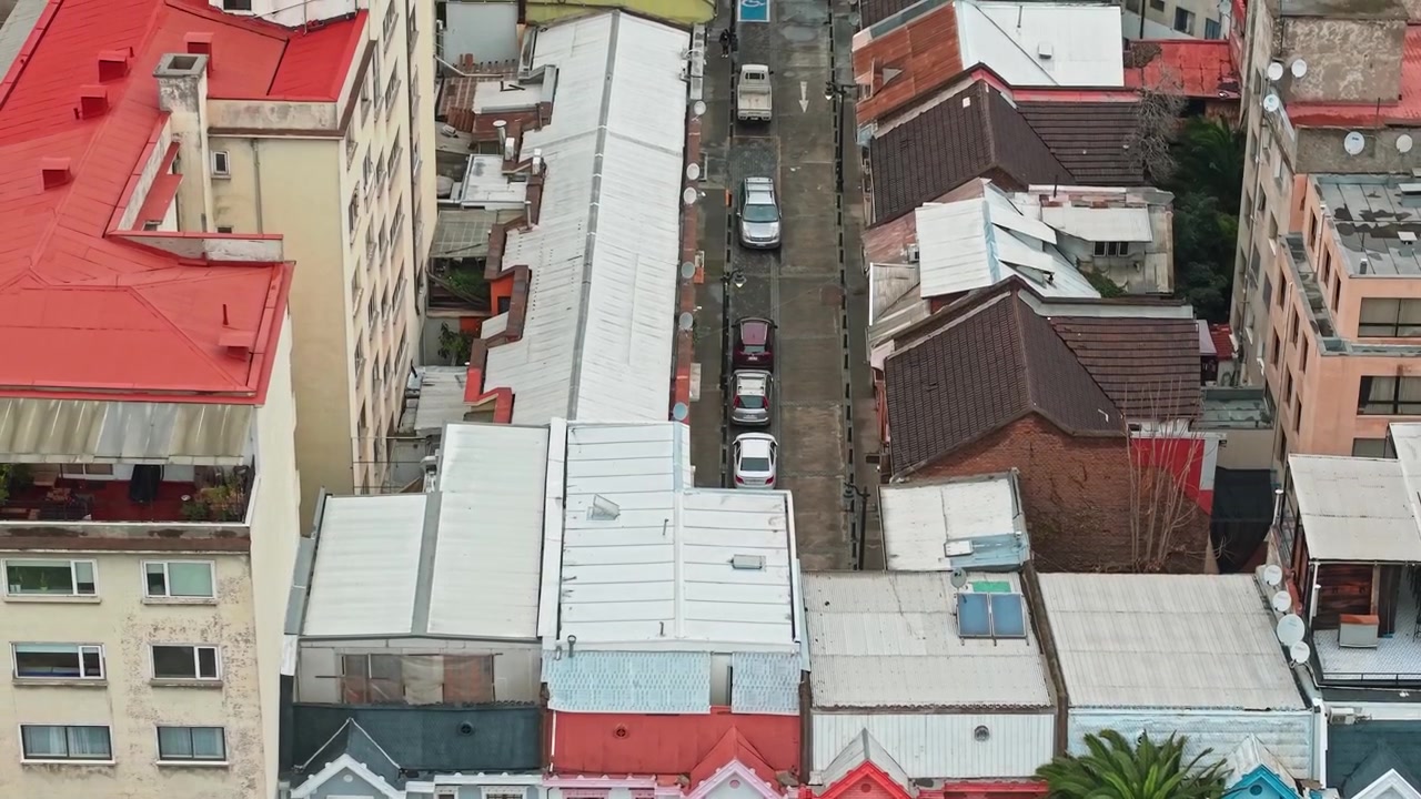 Aerial high angle shot of colorful houses and rooftops near Bustamante Park, Chile