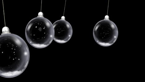 animación de bolas de navidad colgando con nieve cayendo sobre un fondo negro