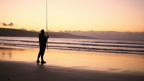 silhouette of a fisherman fishing with a fishing rod