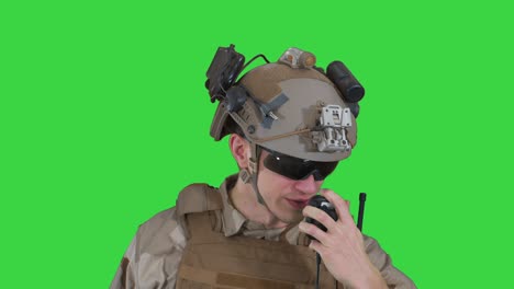 us ranger in uniform talking on radio on a green screen, chroma key