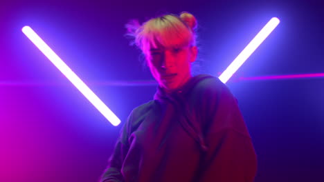 Blonde-artist-dancing-hip-hop-at-neon-lights-close-up.-Girl-performing-freestyle