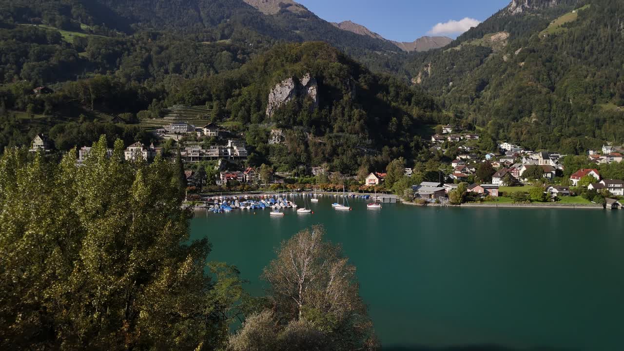 Stunning Aerial View of a Picturesque Alpine Village on a Calm Lake