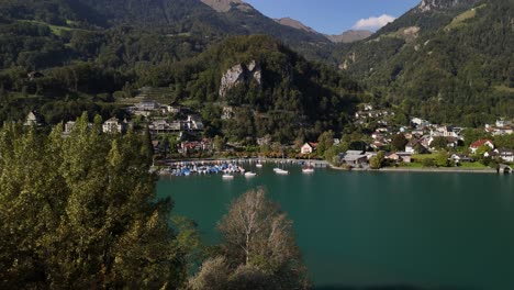 stunning aerial view of a picturesque alpine village on a calm lake