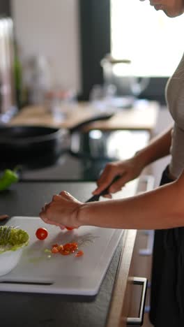 woman preparing fresh vegetables in a home kitchen